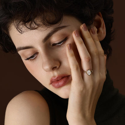 Model wearing Marquise cut lab grown diamond engagement ring in 18K yellow gold 