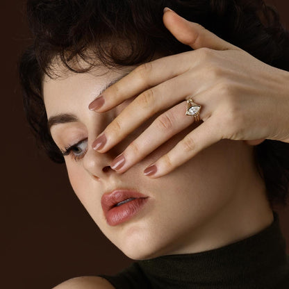 Marquise cut lab grown diamond engagement ring in 18K yellow gold worn on hand