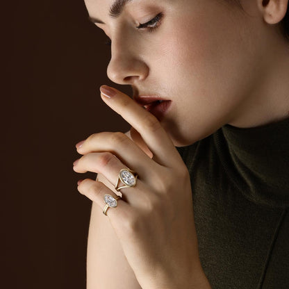 Model wearing moval cut lab grown diamond engagement ring styled with an other ring