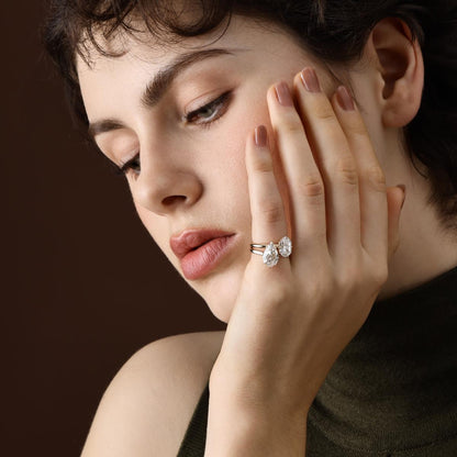 Step cut pear lab grown diamond engagement ring shown on hand in a stacked styling