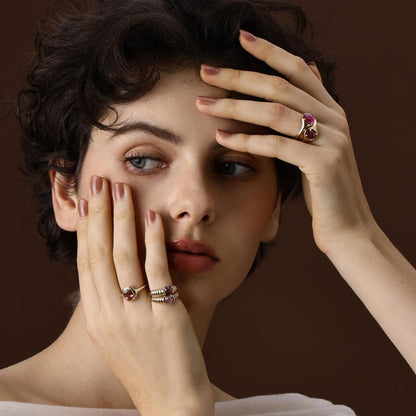 Model wearing a Cushion Cut Deep Purple Spinel Ring styled with other rings