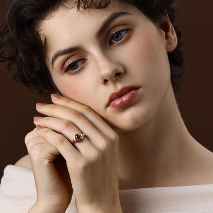 Model wearing the Evie Oval Cut red Tourmaline Ring in 14K Yellow Gold