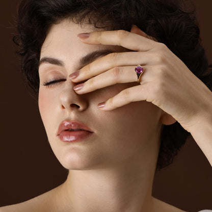 Model Wearing the Evie Oval Cut Lab Grown Pink Sapphire Ring in yellow gold
