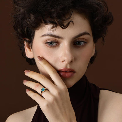 Juno Oval Cut Lab Grown Paraiba Ring in yellow gold worn on hand
