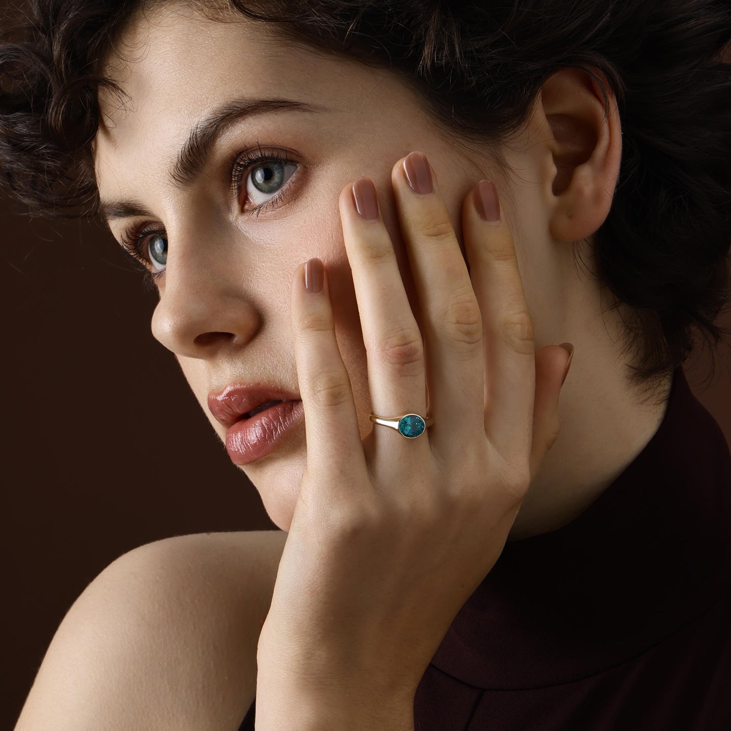 Model wearing an Oval Cut Lab Grown Paraiba Ring in yellow gold