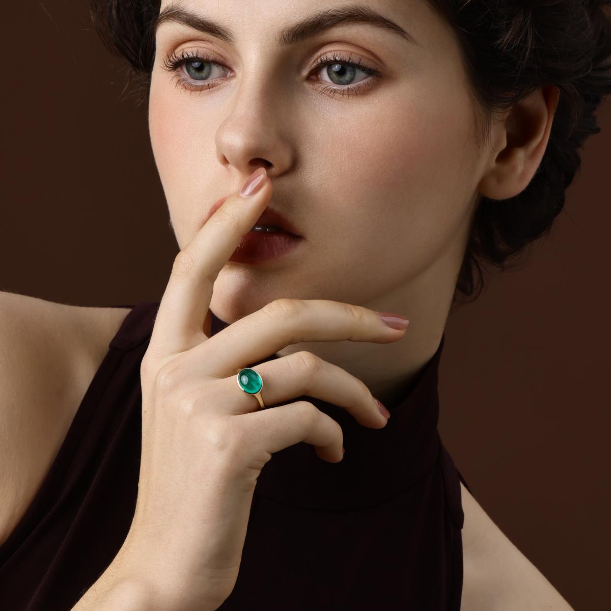 Model Wearing an Oval Cut Lab Grown Emerald Ring in 14K Yellow Gold