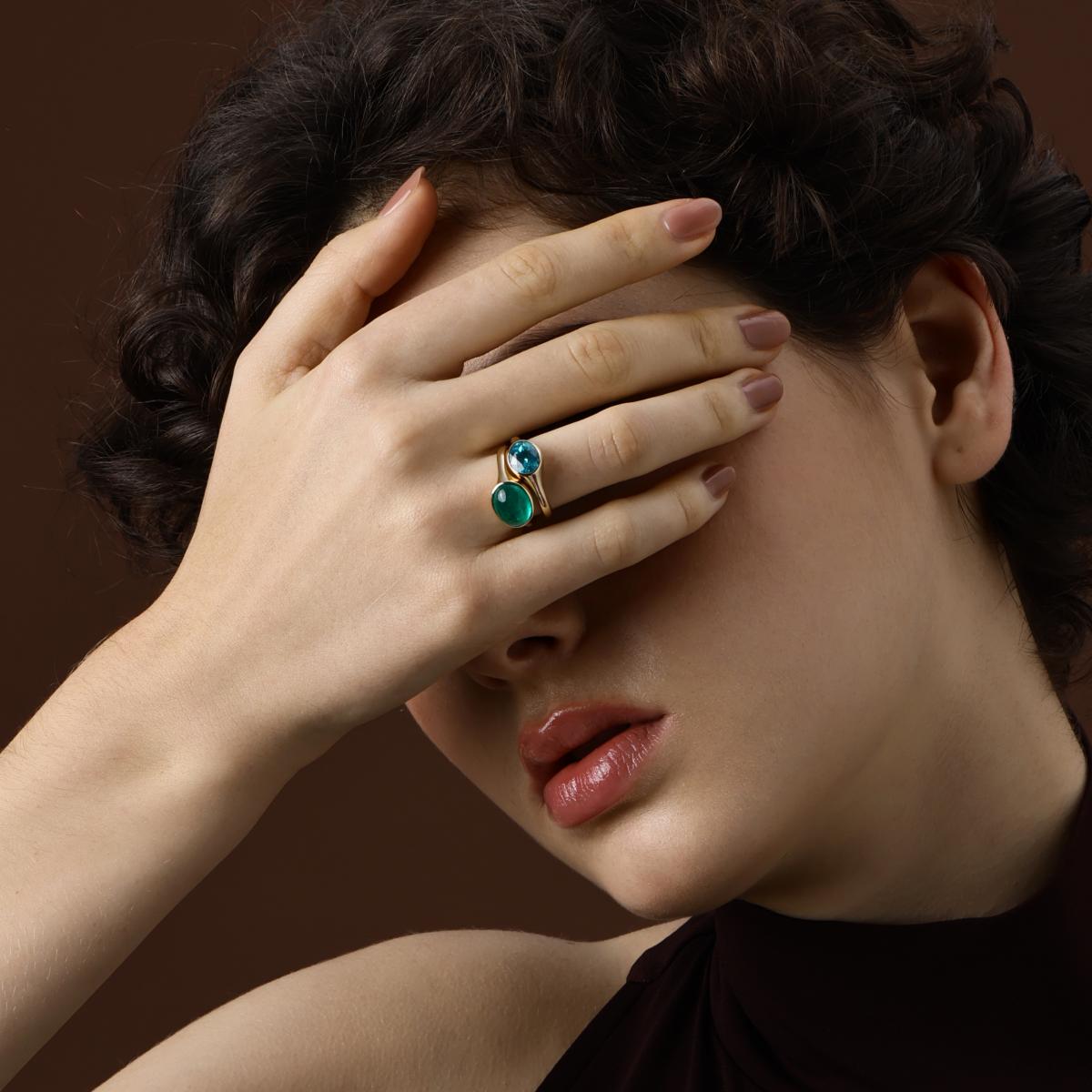 Model Wearing an Oval Cut Lab Grown Emerald Ring styled with an Oval Cut Lab Grown Paraiba Ring