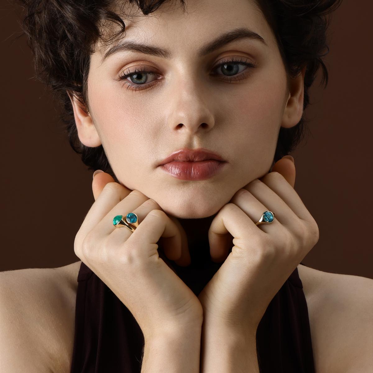 Model wearing the Evie Oval Cut Lab Grown Paraiba Ring styled with 2 blue Gemstone Rings