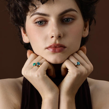 Model wearing the Evie Oval Cut Lab Grown Paraiba Ring styled with 2 blue Gemstone Rings