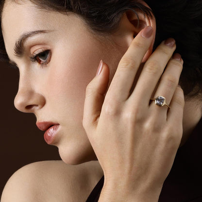 Model wearing Cushion Cut Grey Spinel Ring in 14K yellow gold