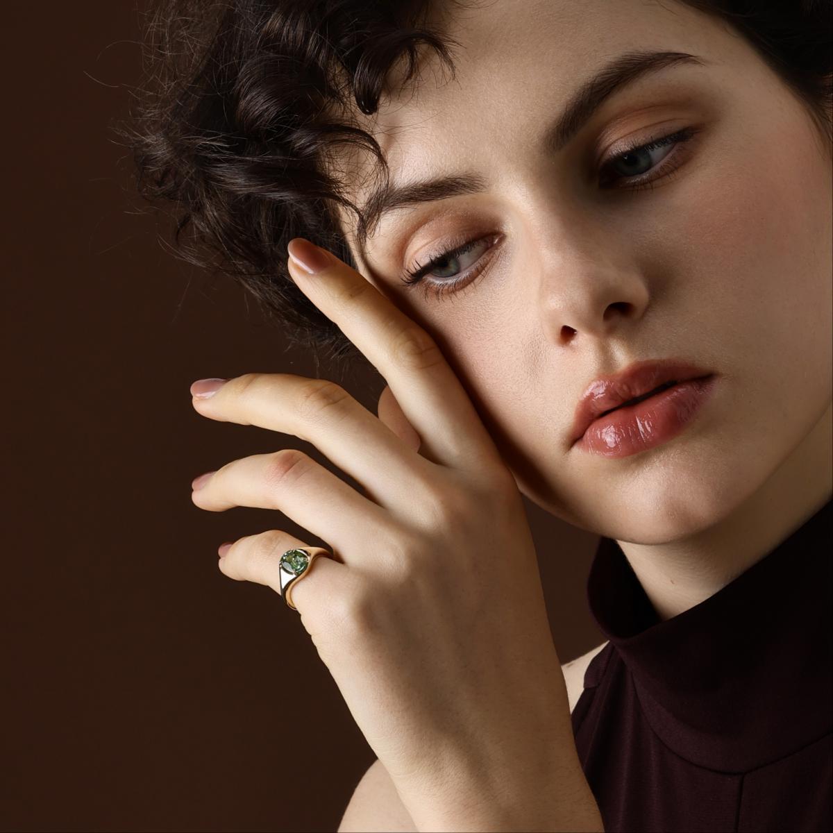 Model wearing Oval Cut Green Tourmaline Ring in yellow gold