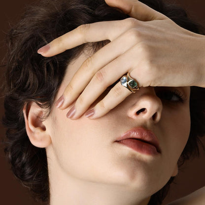 Model wearing Sugarloaf Cabochon Green Tourmaline Ring styled with a Sky Blue Aquamarine Ring