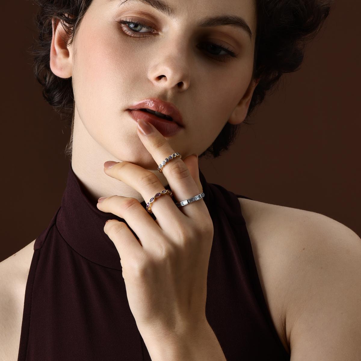 Baguette cut topaz eternity band styled with other rings