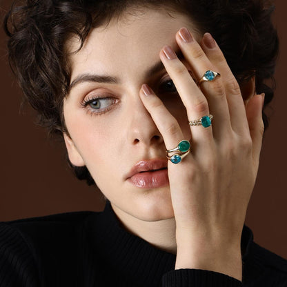 Model wearing Oval Cut Lab Grown Paraiba Ring styled with other Gemstone Rings