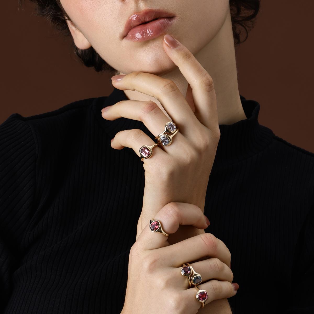 Model wearing cushion cut colored gemstone rings