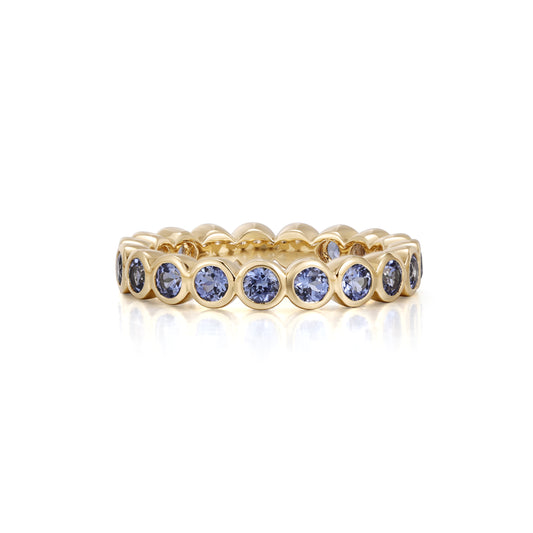 Round cut lab grown blue sapphire eternity band in 18K yellow gold