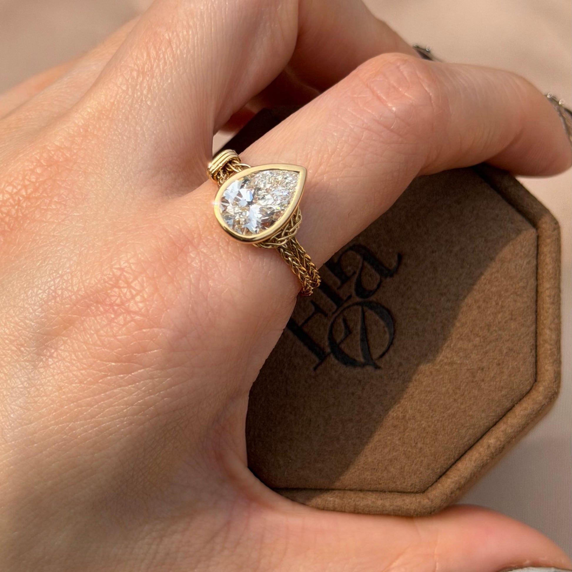 Faith-Pear Cut Lab Grown Diamond Engagement Ring showcased on hand, highlighting the pear cut diamond and golden chain design.