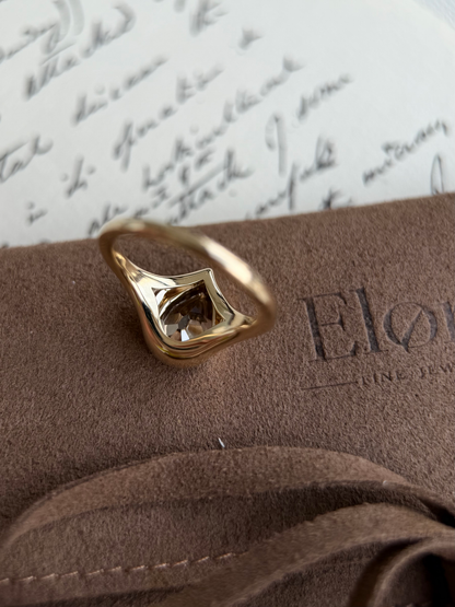 Eddy-Champagne Old Mine Pear Lab Grown Diamond Ring on suede background with antique letter in soft focus.