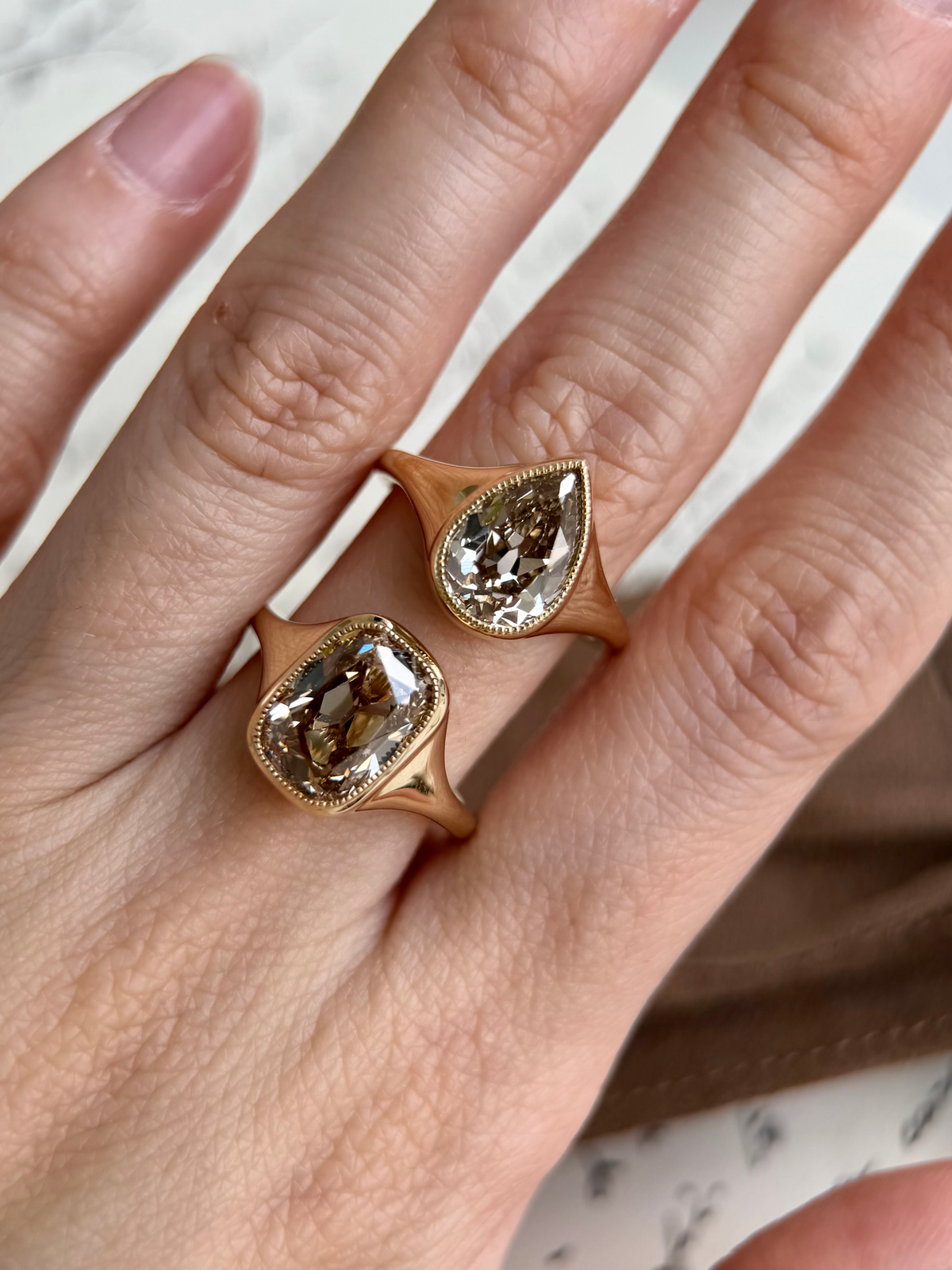 Eddy-Champagne Old Mine Pear Lab Grown Diamond Ring displayed on hand, showcasing vintage design and light brown champagne diamonds.