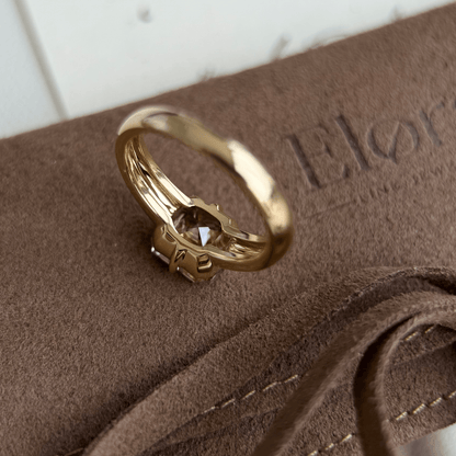 Sintra-Champagne Asscher Cut Lab Grown Diamond Ring displayed on a soft brown surface with elegant detailing.