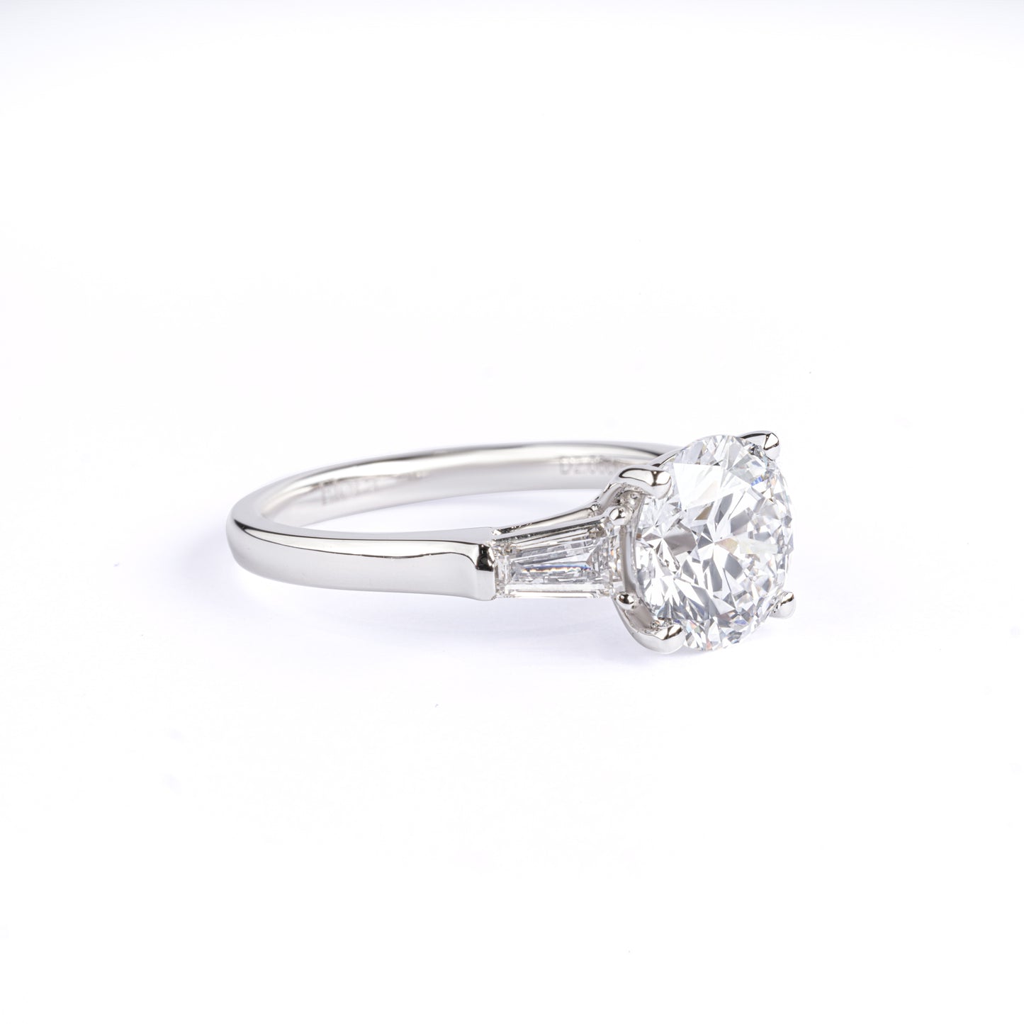Angled View Three-Stone Round Diamond Engagement Ring with two tapered baguette diamonds