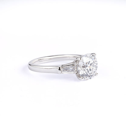Angled View Three-Stone Round Diamond Engagement Ring with two tapered baguette diamonds