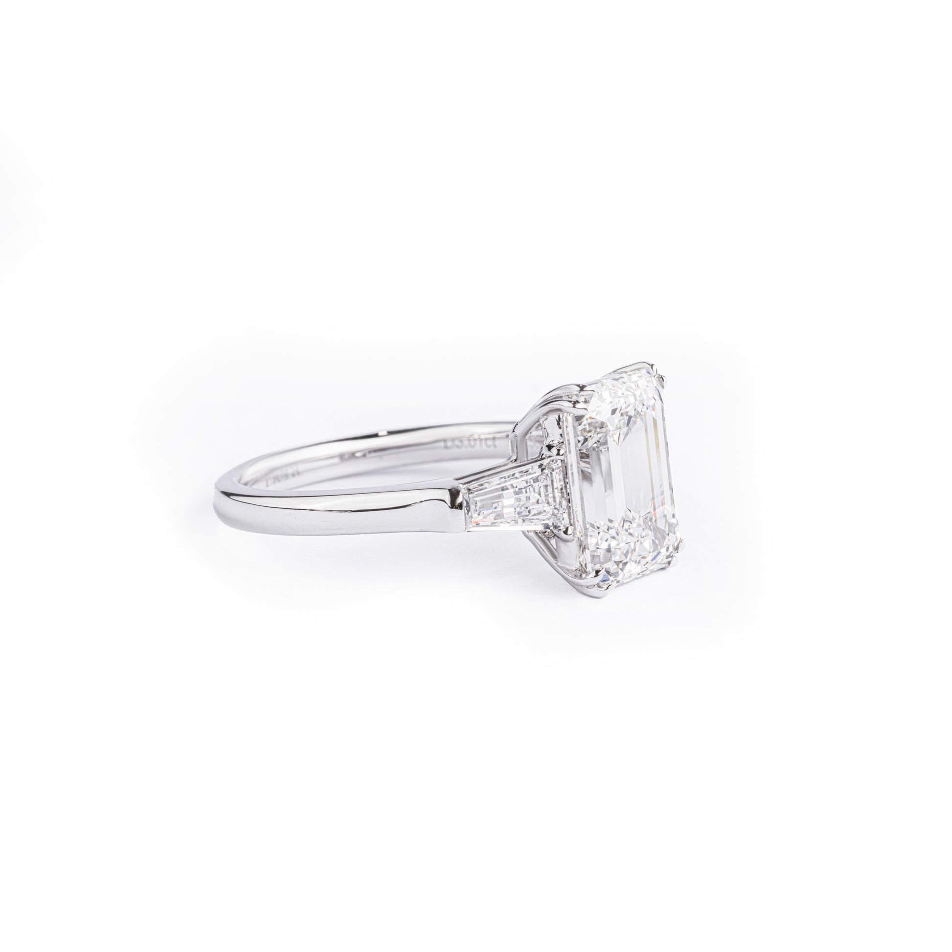 Angled View Three Stone Emerald Cut Diamond Engagement Ring with 2 trapezoid diamonds
