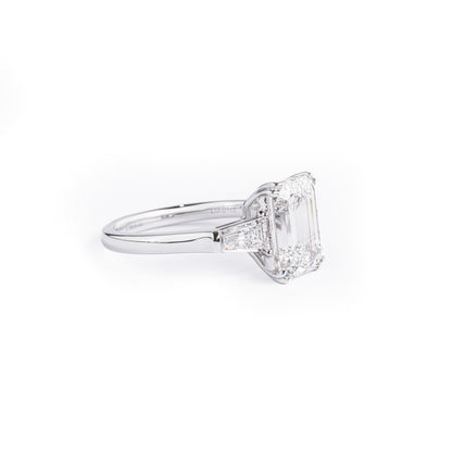 Angled View Three Stone Emerald Cut Diamond Engagement Ring with 2 trapezoid diamonds