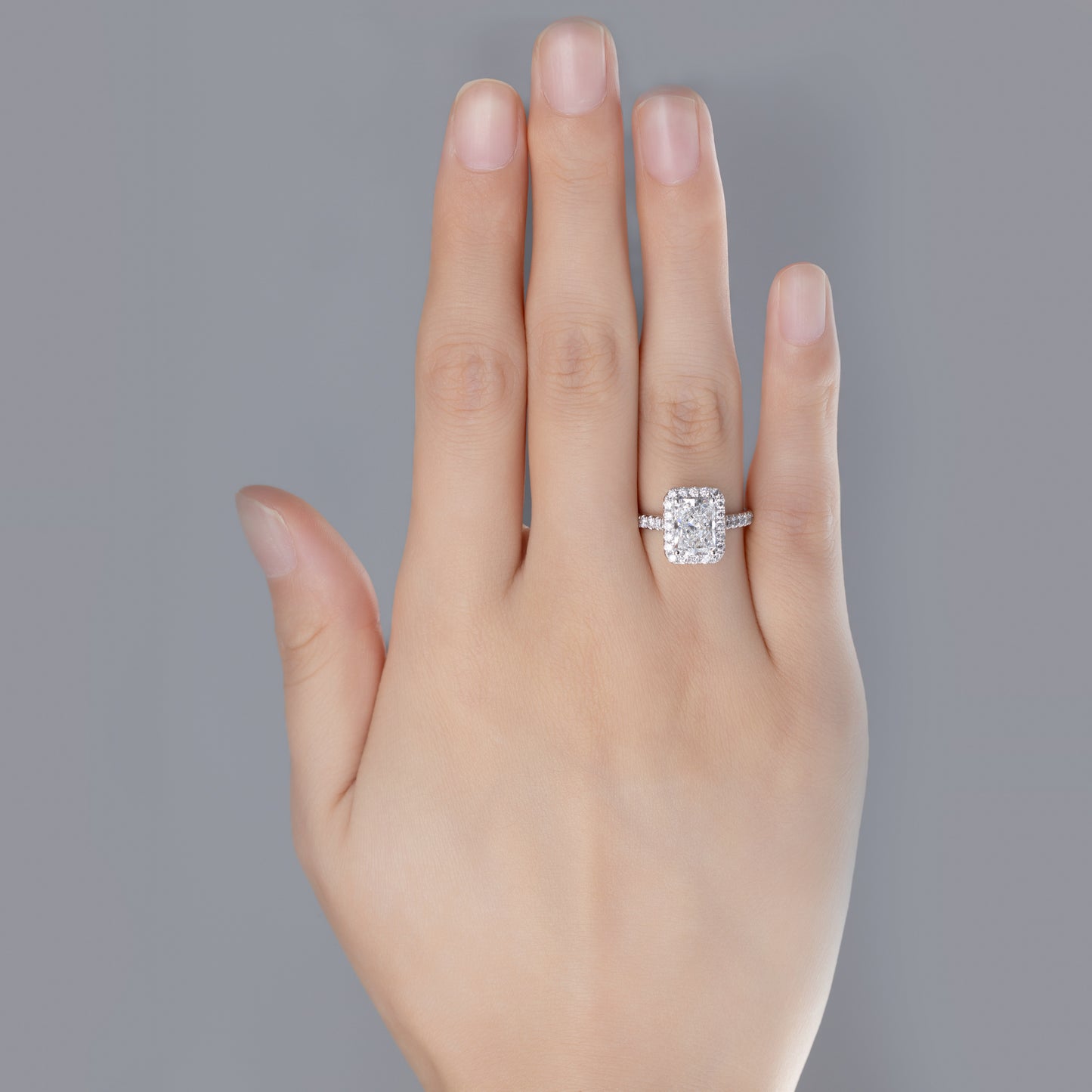 Briella Radiant Cut Pavé Lab Grown Diamond Halo Ring in platinum on ring finger