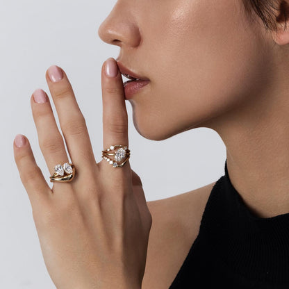 Clara contour ring stacked with solitaire engagement ring, forming a perfect arc