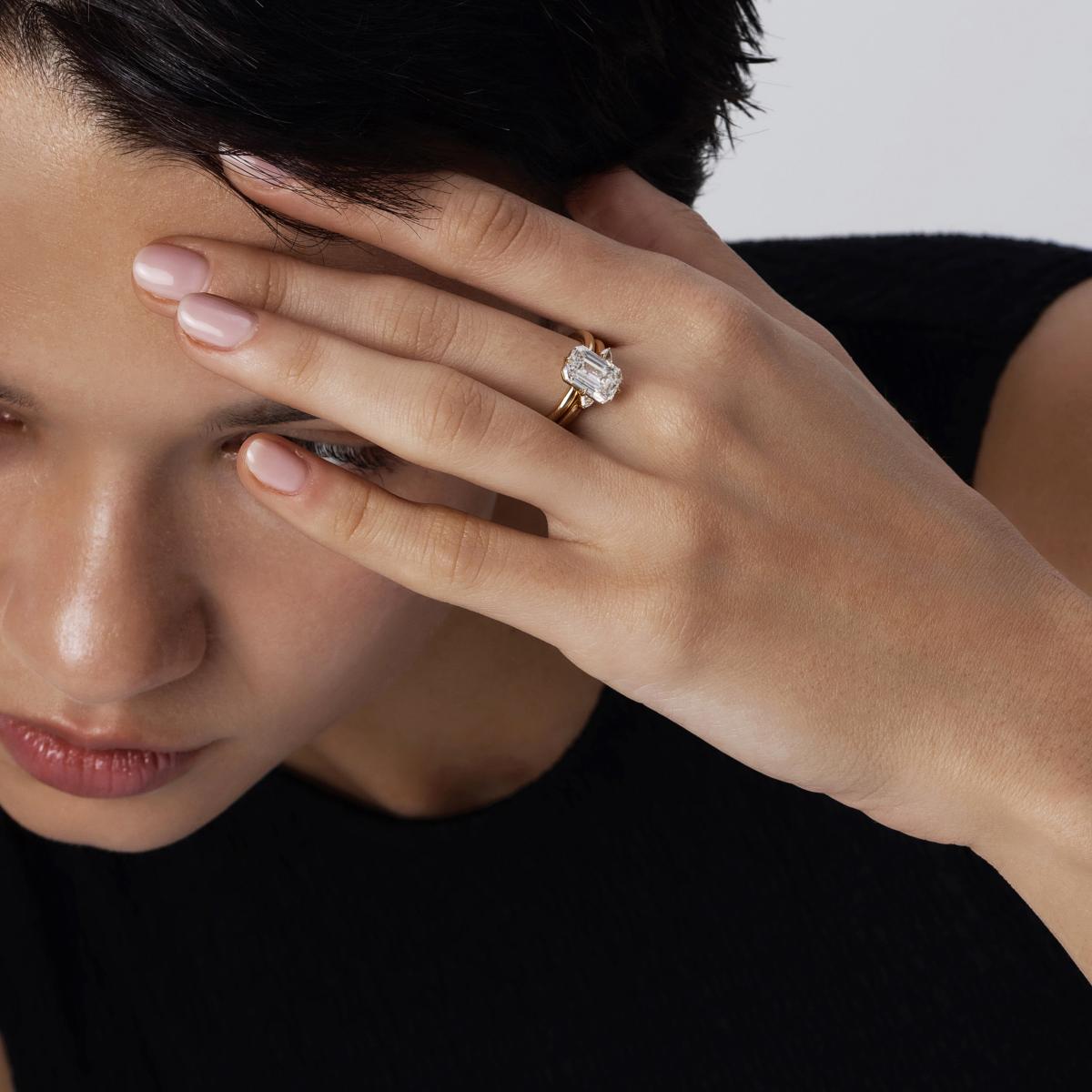 Classic bridal stack featuring a Emerald cut solitaire diamond ring and open band in 14K gold