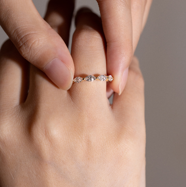 Close-up detail of Maeve pavé diamond eternity band on model’s finger