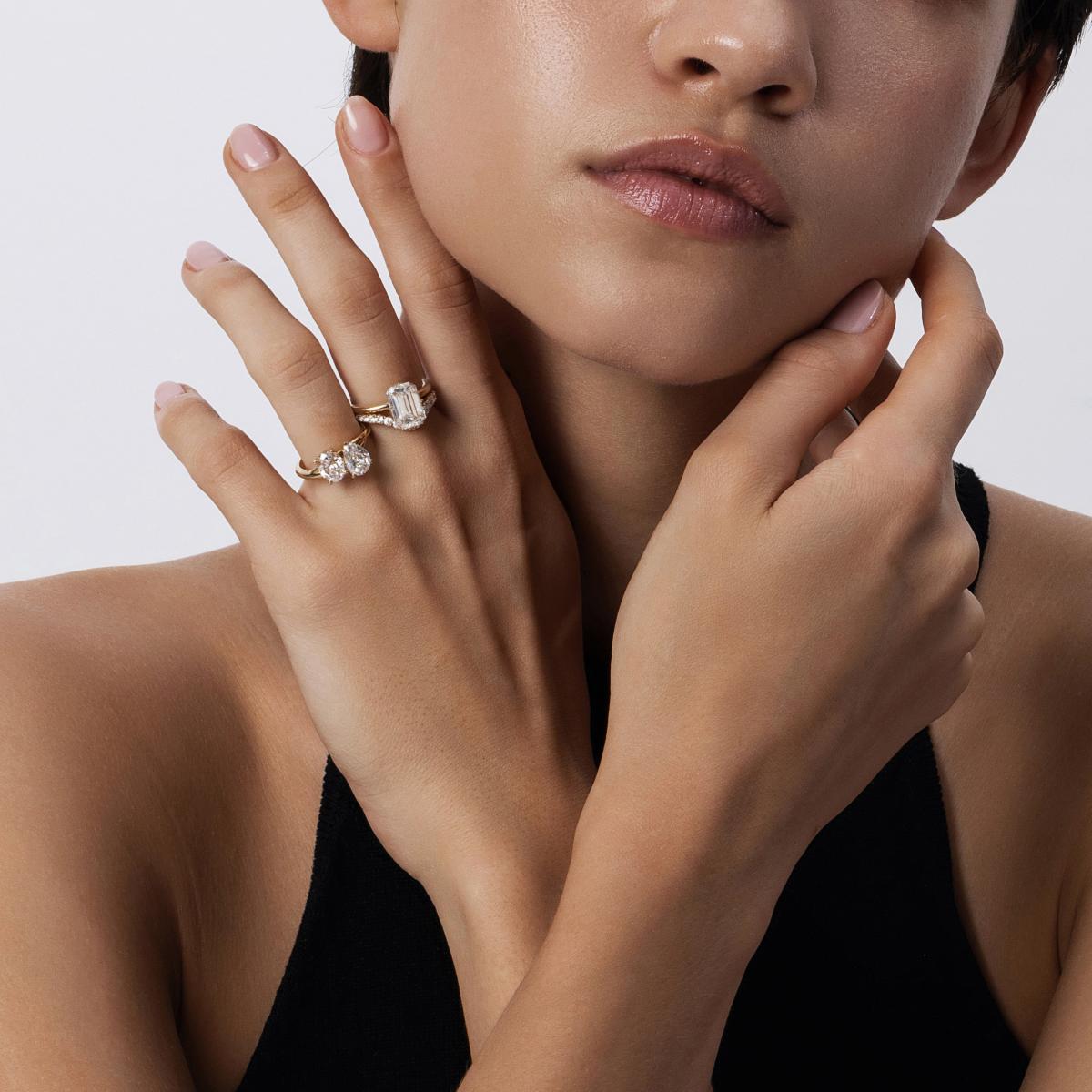 Close-up hand shot of Ivy Pear and Oval Cut 2 Stone Diamond Ring