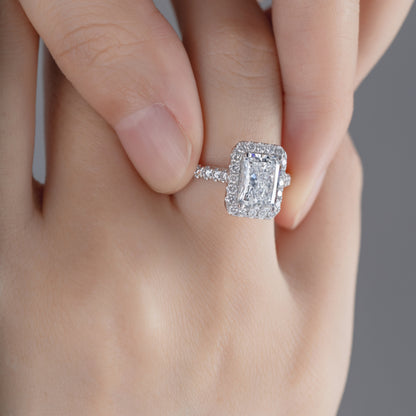 Close-up of Radiant cut Lab Grown diamond in a pave setting Halo Engagement Ring on model’s finger