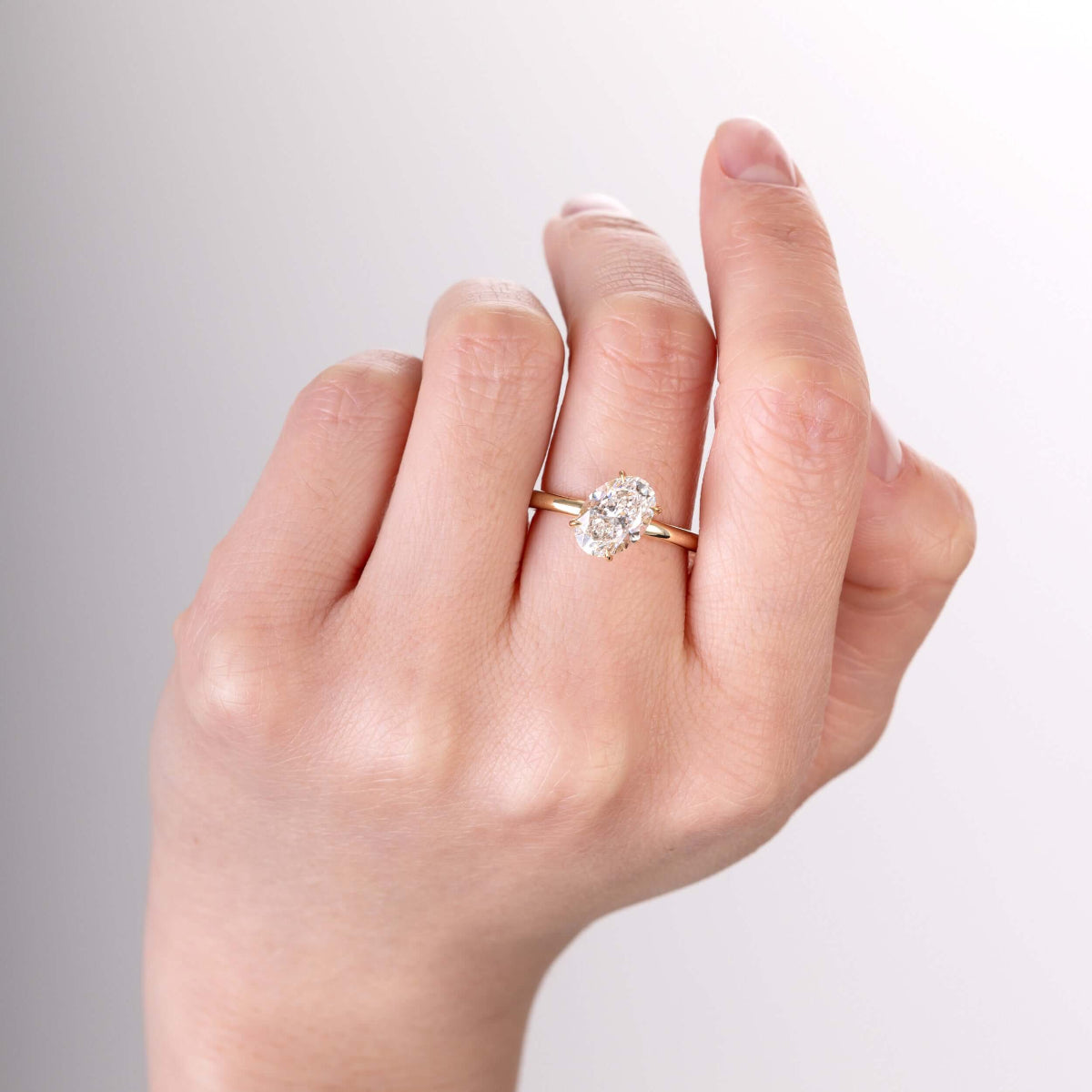 Close-up of the center oval-shaped lab-grown diamond sparkling in light
