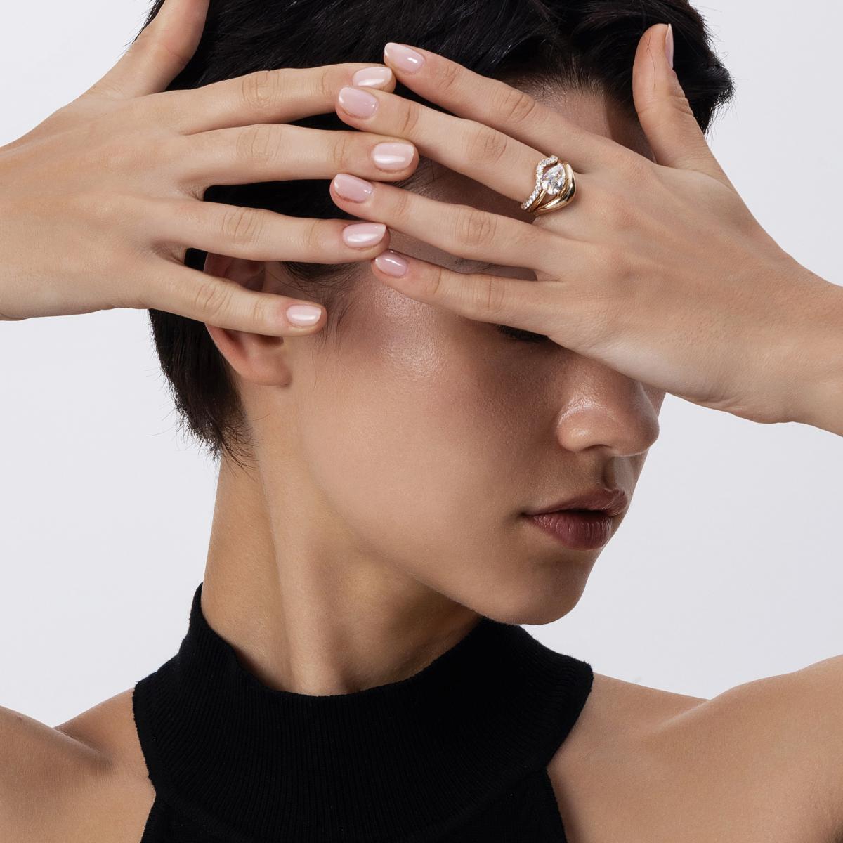East-West Engagement ring and matching contour bands stacked on model’s hand