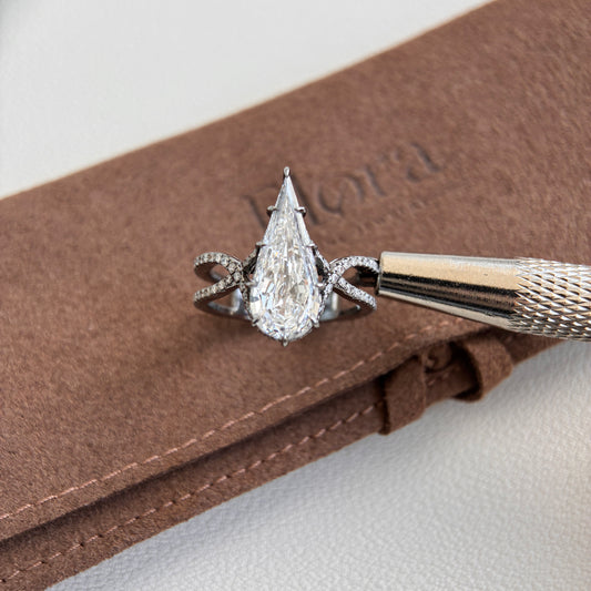 Botany-3.05ct Pear Step Cut Lab Grown Diamond Ring displayed on a brown velvet background with a tool.