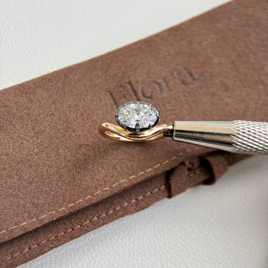 Eva-1.04ct Oval Cut Lab Grown Diamond Pinky Ring on a soft brown pouch.