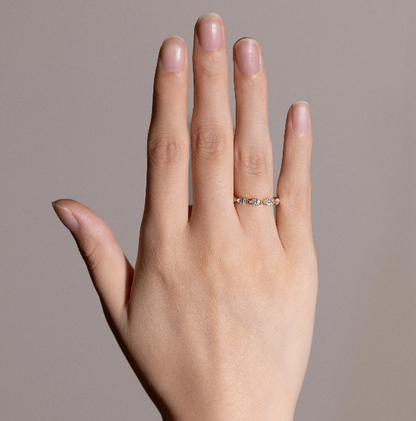 Maeve eternity wedding band worn alone on finger, glowing with delicate sparkle