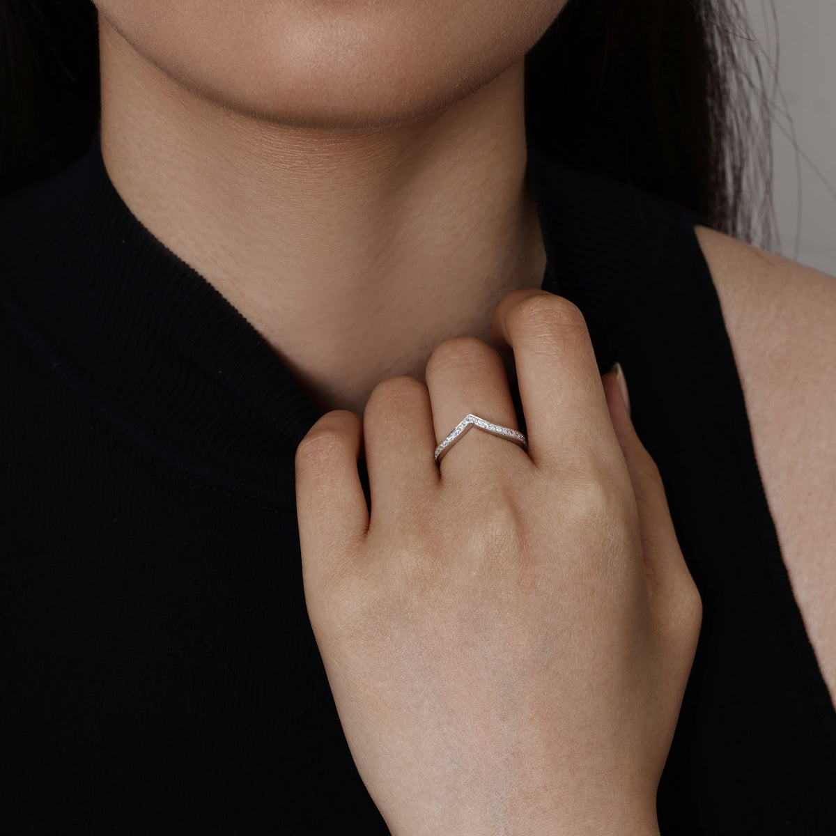 Model wearing Chevron Contour Pavé-set round Diamond Wedding Band in Platinum 2.6mm band width