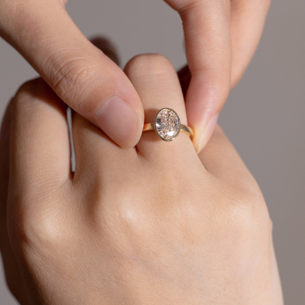 Model wearing Eleanor diamond ring on ring finger, highlighting its elegance