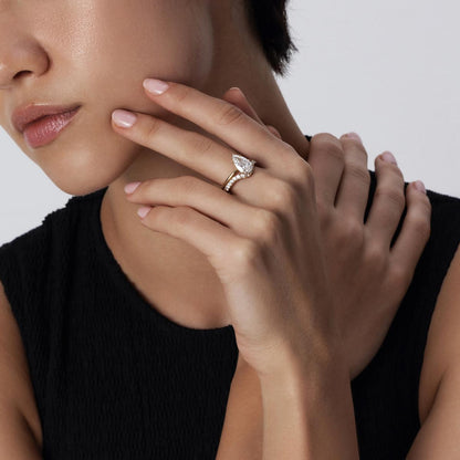 Model wearing Hannah Pear Cut Diamond Ring stacked with a contour pavé band
