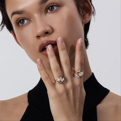 Model wearing Ivy Pear and Oval Cut Diamond Ring stack with a contour band
