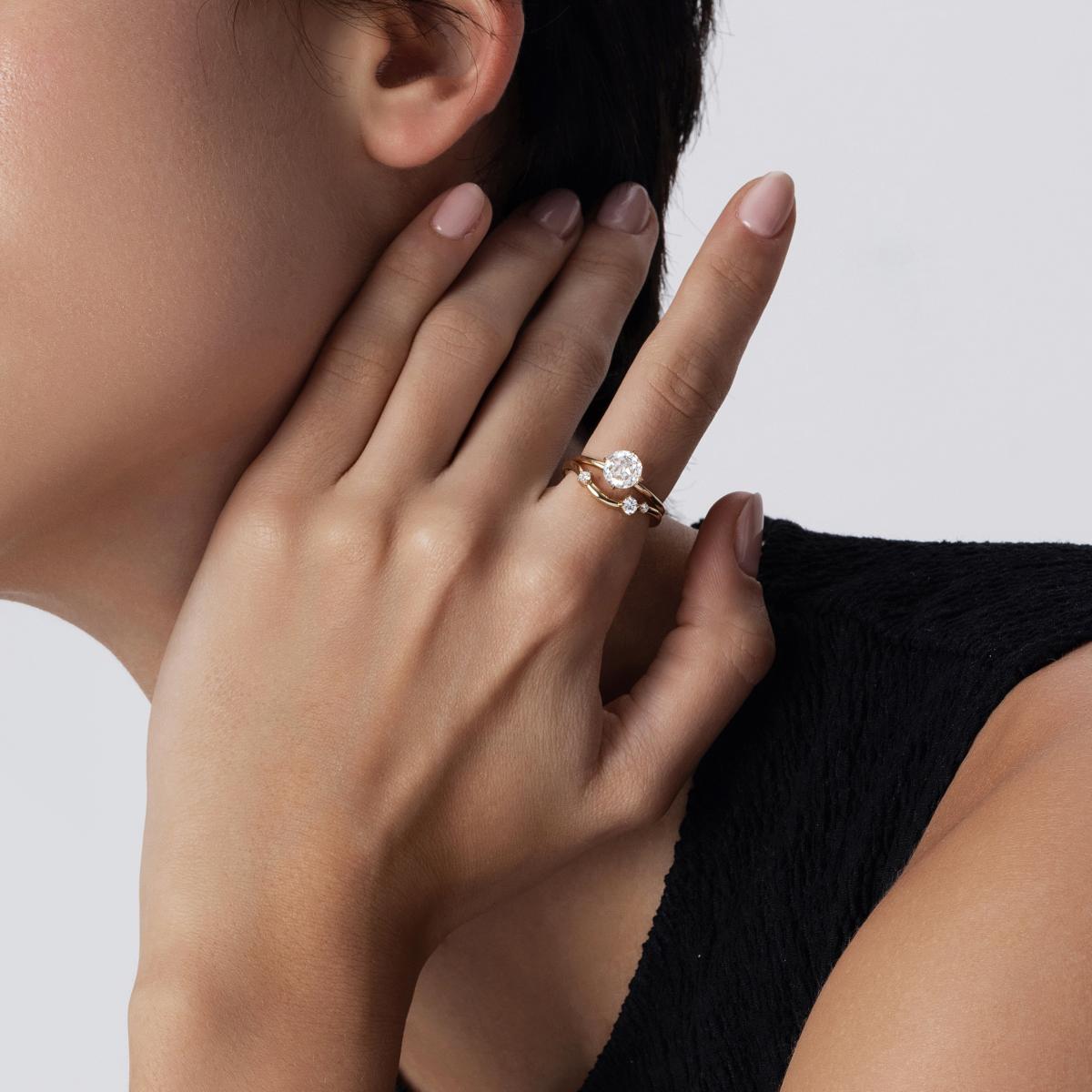Model wearing Rose-cut lab-grown diamond ring stacked with a curved wedding band