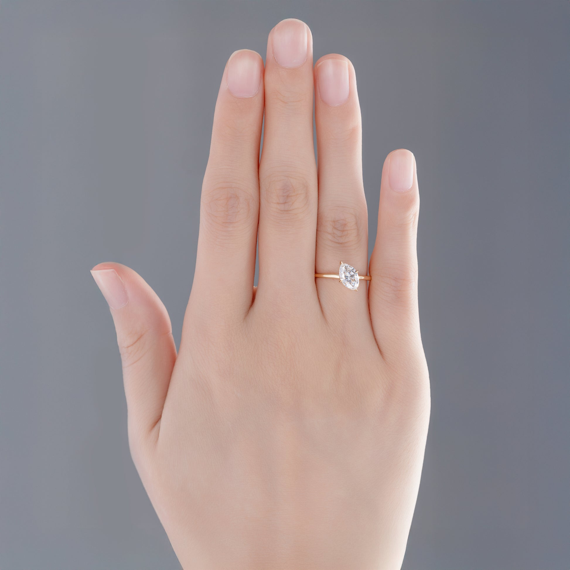 Model wearing Tilted marquise lab-grown diamond engagement ring on finger
