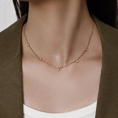 Model wearing a 5 bezel-set round cut Diamonds Station Necklace