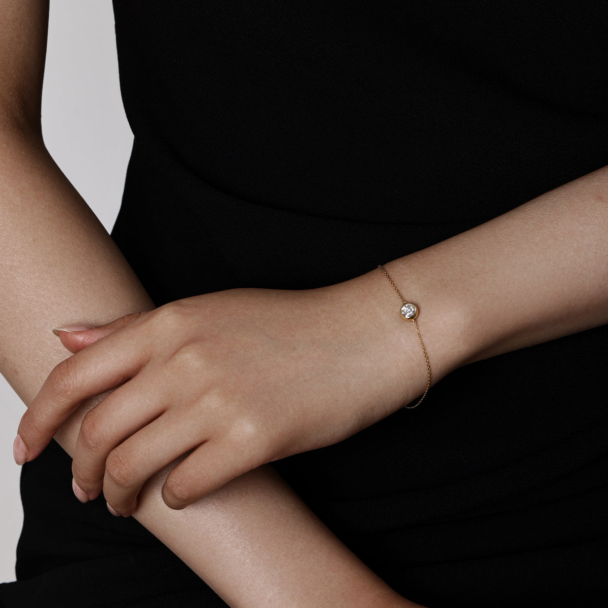 Model wearing a Bezel Round Cut Diamond Bracelet 5.2mm & 3mm Diamond diameters