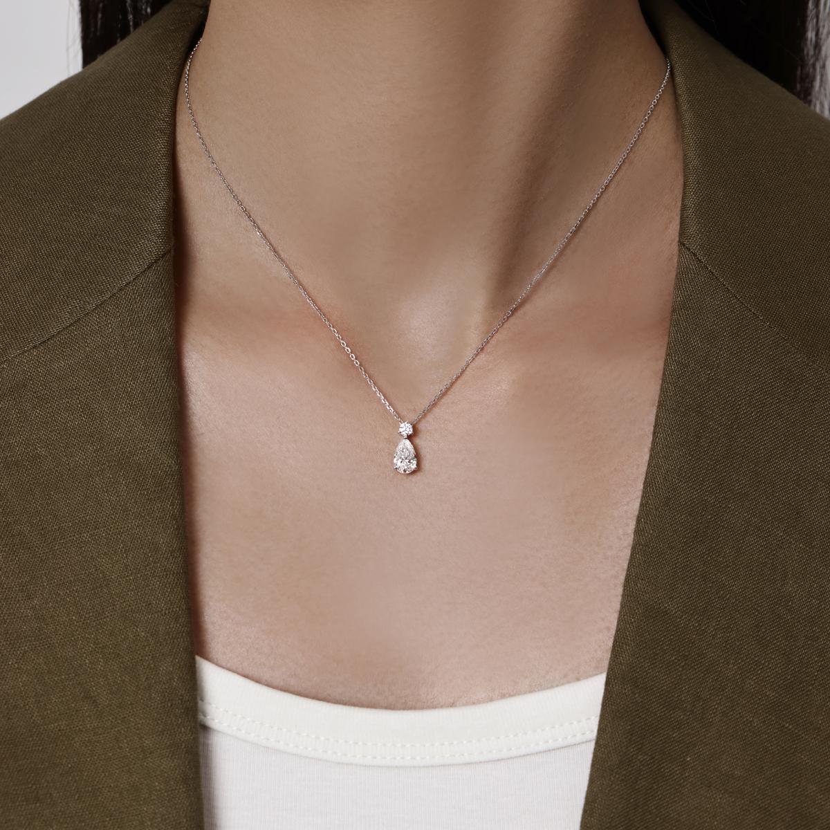 Model wearing a Pear Cut Diamond Pendant Necklace in Platinum 8×5mm Diamond dimensions