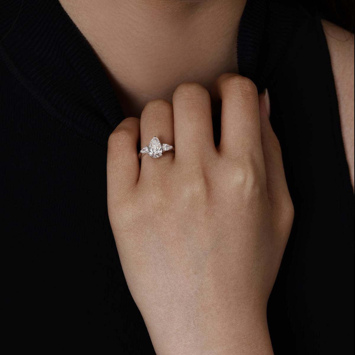 Model wearing a Three Stone Pear Shaped Lab Grown Diamond Engagement Ring in Platinum 2.5mm band width