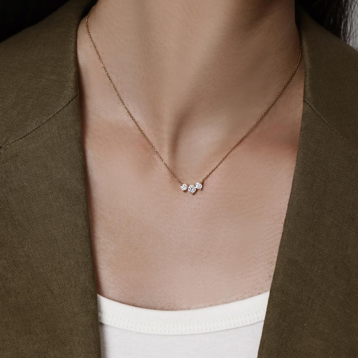 Model wearing a Three Stone Round cut Diamond Necklace 16–18" Chain Length (adjustable)